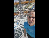 Girl walking up stairs of high waterslide 