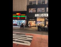 Batman stares at poster stands outside store