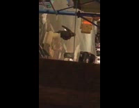 man black jacket pushing white sofa in street