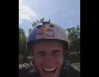 Guy balances on side of wakeboard on white ramp and lands in the water