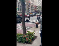 Man holding dust pan with rat at other end 