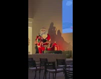 Two women dress Santa Claus Statue pictorial