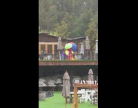 Girl six open umbrellas rainbow red tracksuit 