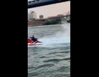 Guy with joker face paint rides jet ski 