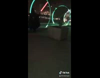 Night time lights skateboard jumps over guy starwars