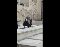 Two girls black dress model  walk on closed fountain