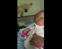 Baby looks at father with cream mask