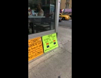 Guy protests in street for gay rights against Donald Trump, orange green posters