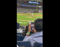 Guy take multiple pictures girl yankess hat