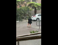 Woman black jacket panorama rain street flood