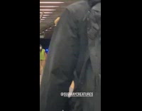 Guy carries trump head stick subway platform