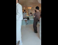 Woman bar counter poses for photo behind