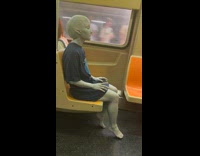 Alien in T shirt ride subway train