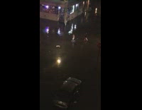 Two girls walking across flooded street