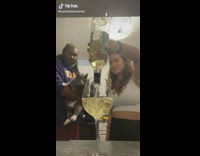 Girl pours entire bottle of wine into single glass 