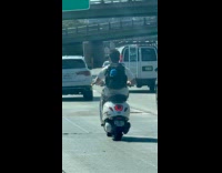 Submitter shows man ride scooter on highway