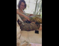 Lady and cat play patty cake hand game 