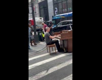 Man playing piano with wheels on crosswalk