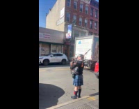 Man perform plays pipe on the street