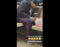 man eating chicken on train throws bones on floor