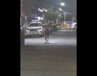 Man carries woman trips on the street