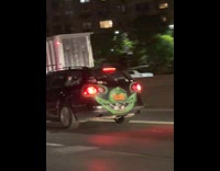 Black car drives with face 