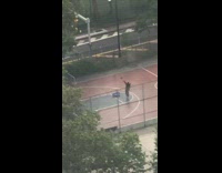 Guy puts umbrella down to play basketball 