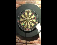 Guy hand on dartboard yellow dart restaurant 