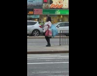 Woman dances on sidewalk in public