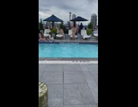 Woman violet bikini dances on the poolside