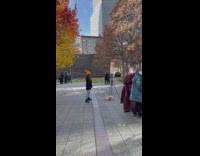 Woman with yellow beanie poses in front of tripod