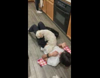 Dog on top of girl on floor