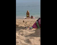 Woman yellow bikini kneel in front of friend