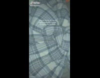 Girl sleeping in bed under blanket with her foot across