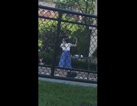 Girl face mask skirt selfie black fence