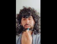 Guy dances with chapstick and wig 