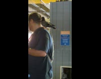 Guy with pigeon on shoulder look at scooter