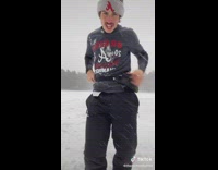 Hockey player pulls an item out of Fanny pack