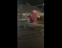 Couple red phone booth photo