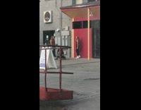 Girl black pants white boot red wall