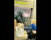 Lady riding subway puts dentures in