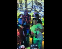 Husbands supporting wives dancing on bar counter