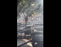 Collab WINY - Man wipes car near fire hydrant spray out water