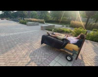 Guy ride remote controlled bed on campus