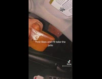 Guy holding jello shot in car window saying take the jello