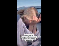 Hungover girl looks miserable on boat 