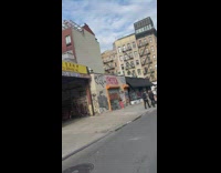 Woman in red orange pants tiktok on the sidewalk