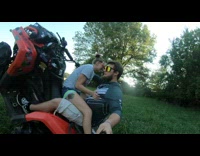 Guy does ATV wheelie with woman on his lap 