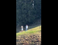 Couple romantic video shoot with tripod downhill