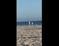 Woman in white bikini weird dance at the beach